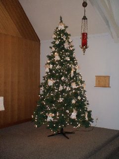 Right: A long tradition in our church, a Christmas tree in our worship space.  Used to be a real tree (partly to show our long heritage as being the Christmas tree farm town); now is artificial just to manage it better. Decorated with strictly Christmas story related items.