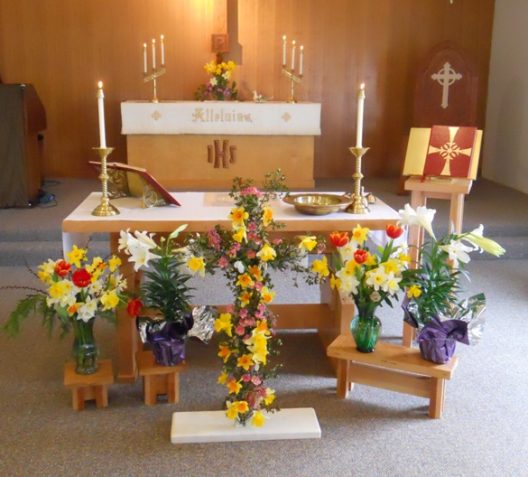 The beautiful Altar Table with the flower offerings in front.