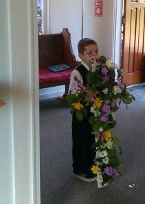 Tyler ready to carry in the flower cross!